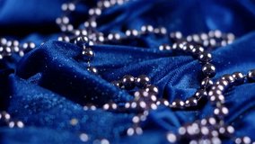 4K Ultra HD Close-Up of Silver Beads on Elegant Blue Fabric – Detailed Shot of Shiny Beads Embellishing Luxurious Textile for Fashion and Decor	 - Powered by Shutterstock - Get 15% off with code: PIKWIZARD15