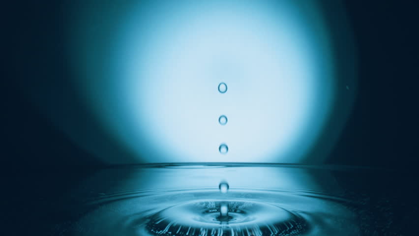 Water drop splash into calm water, slow motion
