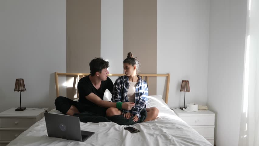 Candid and Heartwarming Moments of a Couple Enjoying Each Others Company in a Cozy Bedroom Setting