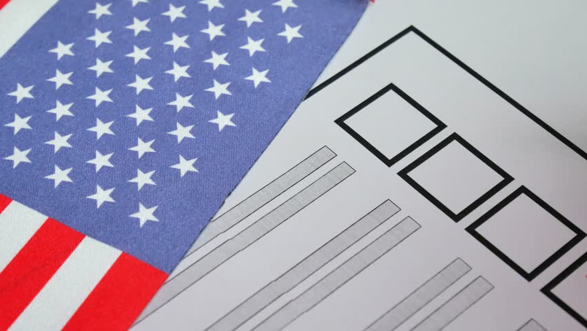 Person selects candidate with red marker on ballot. USA elections. National flag with stars in background. Secure voting process ensures democratic representation and political stability