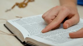 Bible open as woman hand follow scripture study and faith. Finger moves over sacred verse. Christian teachings bring guidance. Holy book offers spiritual devotion and wisdom - Powered by Shutterstock - Get 15% off with code: PIKWIZARD15