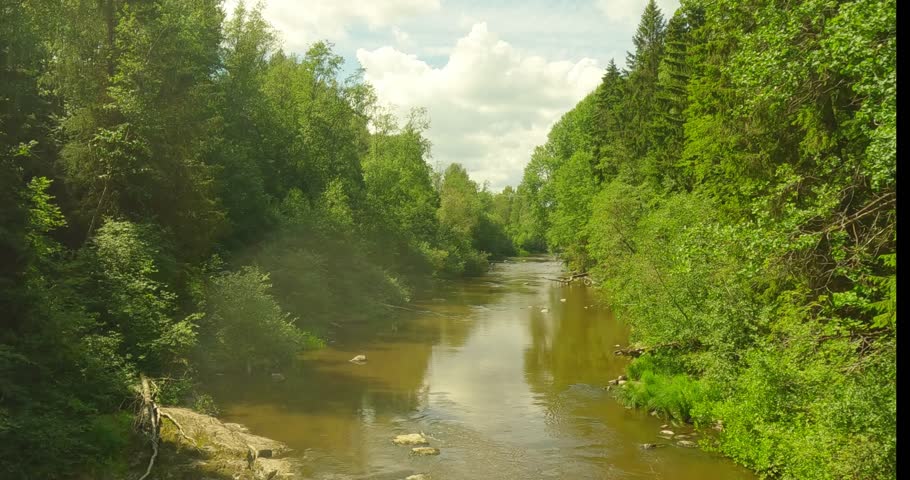 Landscape view at Pitkäkoski rapids in summer with clouds in the sky, Vantaa, Finland.