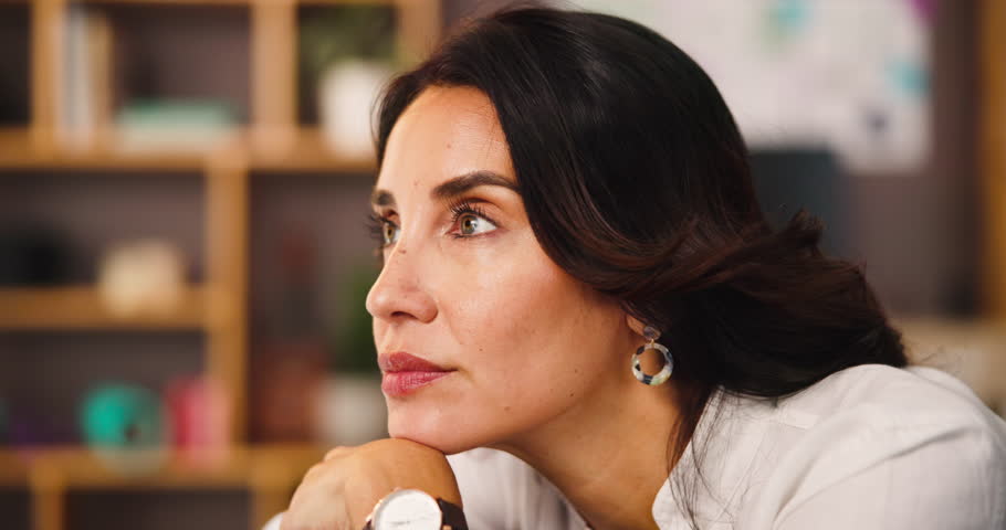 Sad, thinking and woman in home for reflection of mindset, unhappy or lost in thoughts with challenge. Idea, mental health or person with decision, stress or remember serious memory in living room