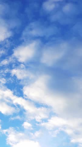 Clouds flying on blue sky background. Vertical footage