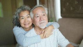 Happy Asian family senior couple looking beautiful nature out of the window together in bedroom. Elderly husband and wife hugging each other with love. Aged people healthcare and mental health concept - Powered by Shutterstock - Get 15% off with code: PIKWIZARD15