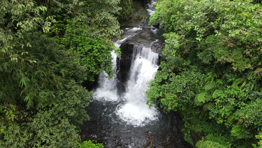 Aerial scenery of hidden and beautifu waterfall in the middle of forest