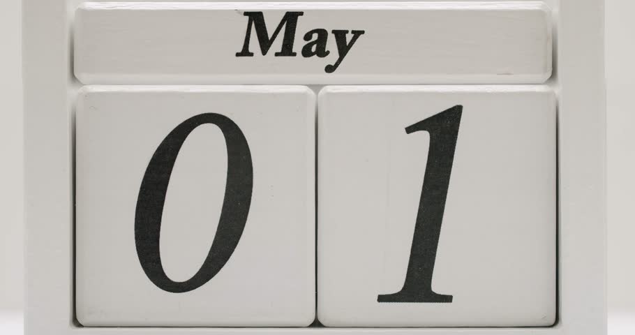 Close up shot of the pages of a wooden calendar flipping through the month of May. Great for videos about time, deadlines, memories, or organization. May Calendar Page Flip Close Up