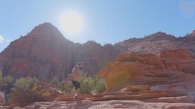 African American male embarks on a hike in Zion National Park, surrounded by stunning red rock formations and vibrant landscapes under a beautiful sky, embracing natures adventure - Powered by Shutterstock - Get 15% off with code: PIKWIZARD15