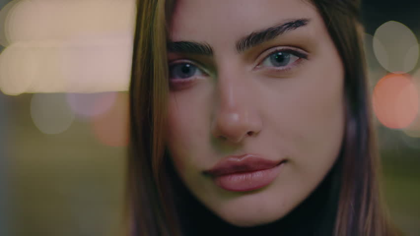 Portrait of charming female. Model posing urban avenue. Pretty female person posing in city center at night. Natural beauty lady on street. Slow motion.