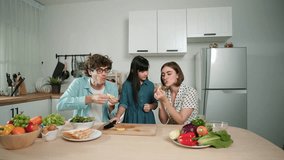Happy caucasian father and mother sitting and eating fruit at modern kitchen. Energetic family spend time together by enjoy eating fruit or healthy fruit with kitchenware and fruit on table. Pedagogy. - Powered by Shutterstock - Get 15% off with code: PIKWIZARD15