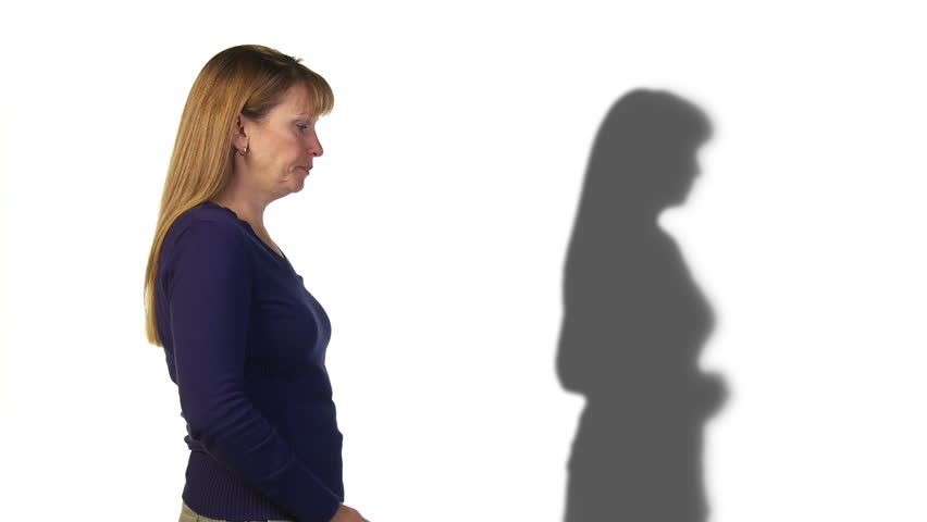 Woman gets angry on a phone call while her shadow remains calm. Recorded on