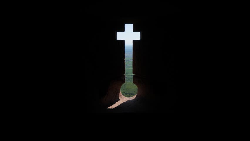 Look out from old castle through round opening at bottom of narrow embrasure. Forested foothills of Vosges mountains and green Alsatian vineyards seen outside, scenic perspective from top point