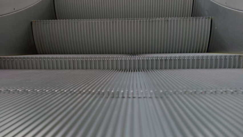 Moving staircase escalator going up close-up