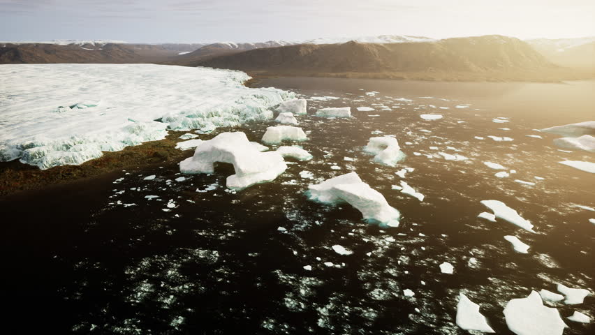 An aerial view of icebergs floating in the water