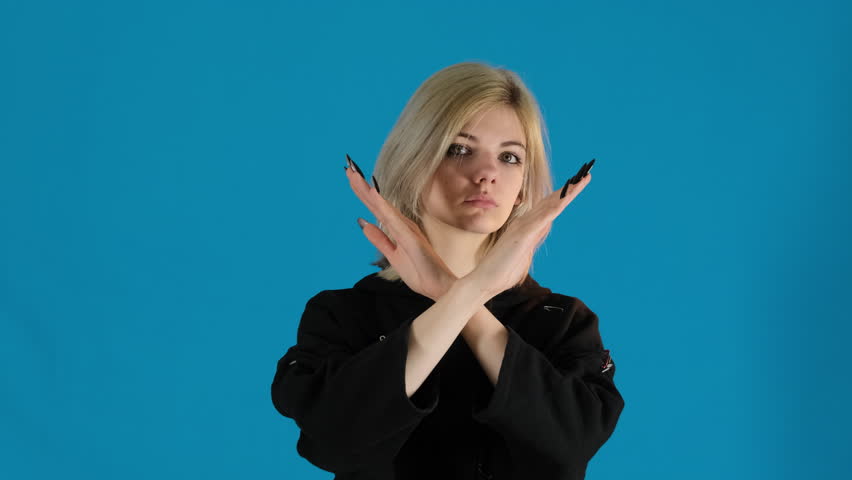 Female model shows stop signal crossing arms in front of face. Enthusiastic young woman suddenly changes emotion and shows thumbs up smiling