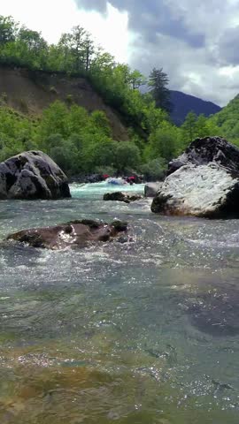 White Water Rafting Adventure - Video Montage. People in Inflatable Rafts Paddling Through River Rapids. Whitewater Rafting Aerial View. Active Vacations. Drone POV of Picturesque River Canyon. Explore the full series of white water rafting videos—search ADRENALIN-RAFT-RIVER-2024 in the search bar for more matching clips.