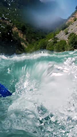 Whitewater Rafting - POV Shot. Whitewater Rafting Team Descending Raging Rapids. Underwater Camera Shots. Active Outdoors Pursuit. Active Living. Mountain River Canyon with People in Rafting Boat.