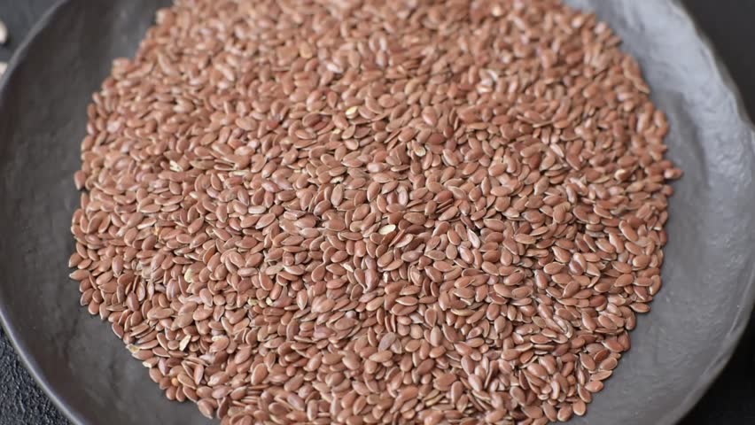 Flax seeds in a bowl, an ingredient for making vegan or vegetarian food. Tasty and healthy food