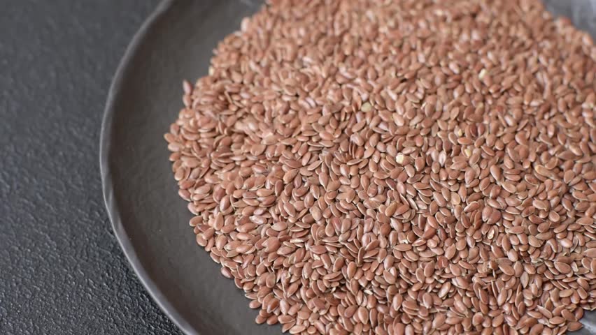 Flax seeds in a bowl, an ingredient for making vegan or vegetarian food. Tasty and healthy food