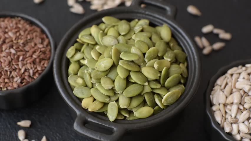 Peeled pumpkin seeds in a bowl, an ingredient for making vegan or vegetarian food. Tasty and healthy food