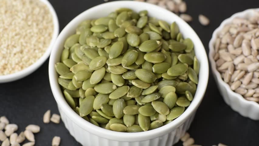 Peeled pumpkin seeds in a bowl, an ingredient for making vegan or vegetarian food. Tasty and healthy food