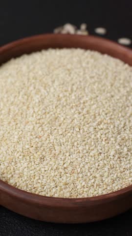 White sesame seeds in a bowl, an ingredient for making vegan or vegetarian food. Tasty and healthy food