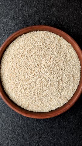 White sesame seeds in a bowl, an ingredient for making vegan or vegetarian food. Tasty and healthy food