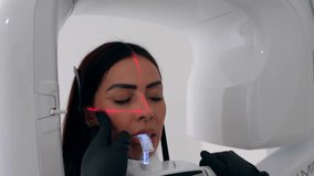 Professional dental hygienist performing comprehensive oral health screening with advanced digital x ray technology on female patient in modern medical facility - Powered by Shutterstock - Get 15% off with code: PIKWIZARD15