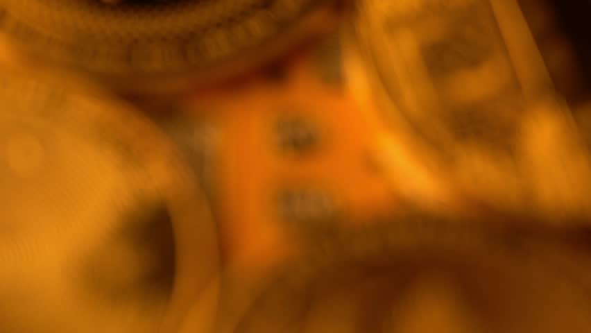 Macro closeup zoom in of stacked cryptocurrency coins with Bitcoin logo dominant
