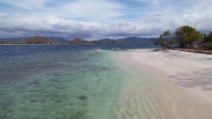 Drone view Tourist walking on a deserted tropical beach in indonesia