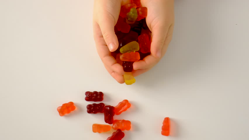 child with jelly beans. Selective focus.