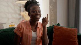 Thoughtful creative happy African American woman female businesswoman girl smiling client thinking idea ponder find excellent solution raised finger up gesture brilliant answer sitting couch at home - Powered by Shutterstock - Get 15% off with code: PIKWIZARD15