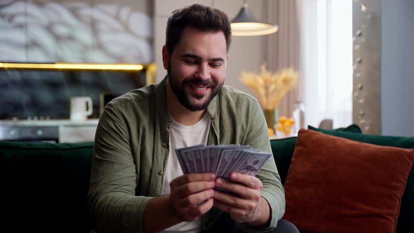 Happy rich wealthy Caucasian business man male guy businessman homeowner client looking camera waving fan money stack cash dollars banknotes finance income wealth win lottery prize profit indoors home