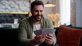 Happy rich wealthy Caucasian business man male guy businessman homeowner client looking camera waving fan money stack cash dollars banknotes finance income wealth win lottery prize profit indoors home - Powered by Shutterstock - Get 15% off with code: PIKWIZARD15