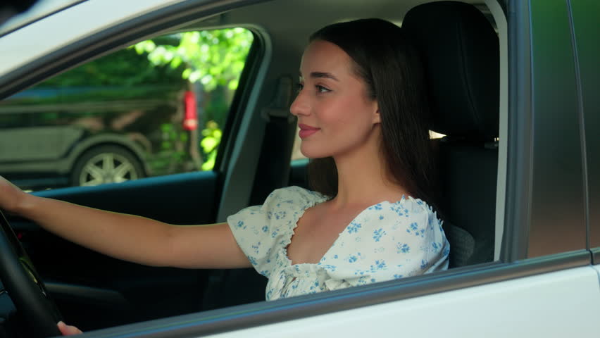 Satisfied happy Caucasian woman female girl client driver auto owner sitting inside automobile vehicle smiling looking at camera showing thumb up approve recommend car transportation rent test drive