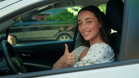 Satisfied happy Caucasian woman female girl client driver auto owner sitting inside automobile vehicle smiling looking at camera showing thumb up approve recommend car transportation rent test drive - Powered by Shutterstock - Get 15% off with code: PIKWIZARD15