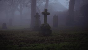 Eerie Graveyard in thick fog and mist medium zoom shot selective focus - Powered by Shutterstock - Get 15% off with code: PIKWIZARD15