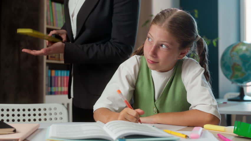 Angry strict teacher professor woman tutor supervising controlling naughty bad behavior little girl Caucasian child school kid student learner writing exam homework task education in classroom library - Powered by Shutterstock - Get 15% off with code: PIKWIZARD15