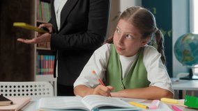 Angry strict teacher professor woman tutor supervising controlling naughty bad behavior little girl Caucasian child school kid student learner writing exam homework task education in classroom library - Powered by Shutterstock - Get 15% off with code: PIKWIZARD15