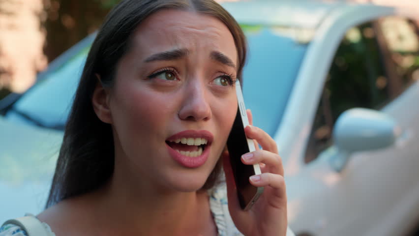 Nervous stressed Caucasian woman female girl lady client despair talking mobile phone call speaking cellphone calling auto service explaining problems with rental automobile trouble car at city street
