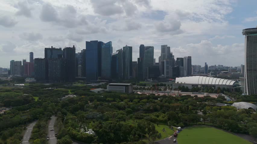 Aerial: Central Business District (CBD) skyline and cityscape during the day in Central Area, Singapore, establishing drone shot