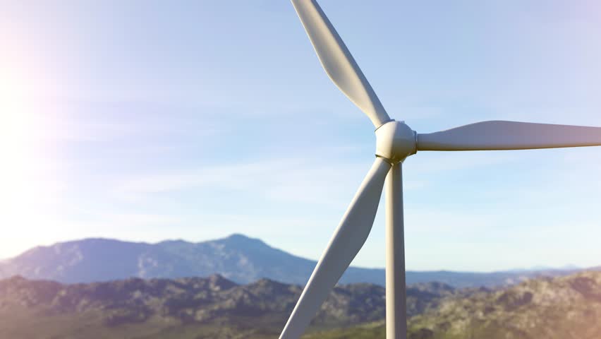White wind turbine rotating its blades, generating clean energy in a beautiful mountainous landscape