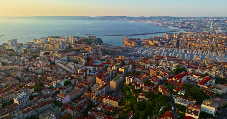 Aerial view of the city of Marseille in the morning sun. Rooftops in French Town. Crowds of people stroll through the coastal town. Drone view of Marseille in the south of France