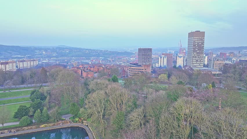 Aerial: Weston Park area with buildings in Sheffield, South Yorkshire, England, jib up drone shot