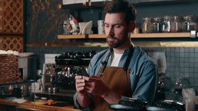 Caucasian worker small business owner employee man scroll app mobile phone entrepreneur chat online guy in cafeteria restaurant barista typing smartphone male waiter buy equipment in Internet remote - Powered by Shutterstock - Get 15% off with code: PIKWIZARD15