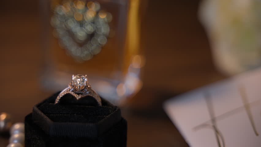 Close up view of the engagement ring in the dark velvet ring box. Wedding Jewelry