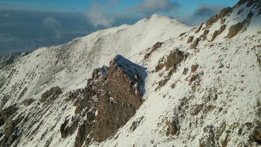 Sunset kisses the mountain with its golden hours rays in Kazachstan near Almaty. National Park Shymbulak aerial shot with drone dji mini 3 pro