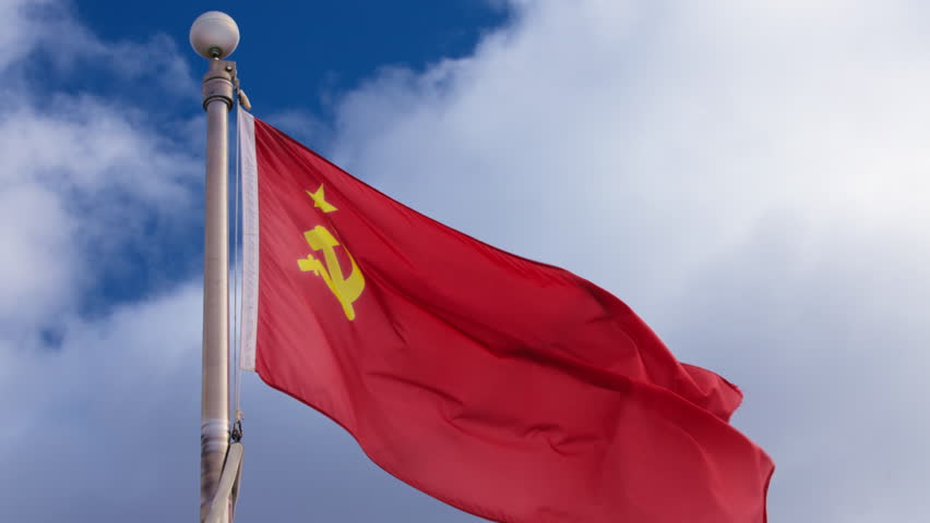 Flag of Soviet Union (USSR) waving in the wind against blue sky. Slow motion.