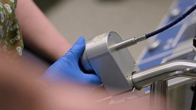 A close-up view of a medical device being operated in a surgical setting, showcasing advanced technology. - Powered by Shutterstock - Get 15% off with code: PIKWIZARD15