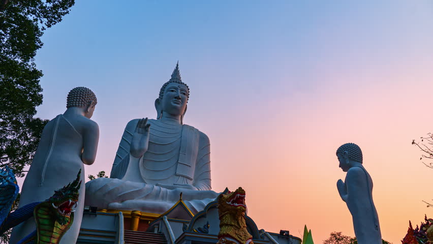 Statue of a standing monks paying homage to the Buddha in a serene temple, exudes a sense of reverence. The monk